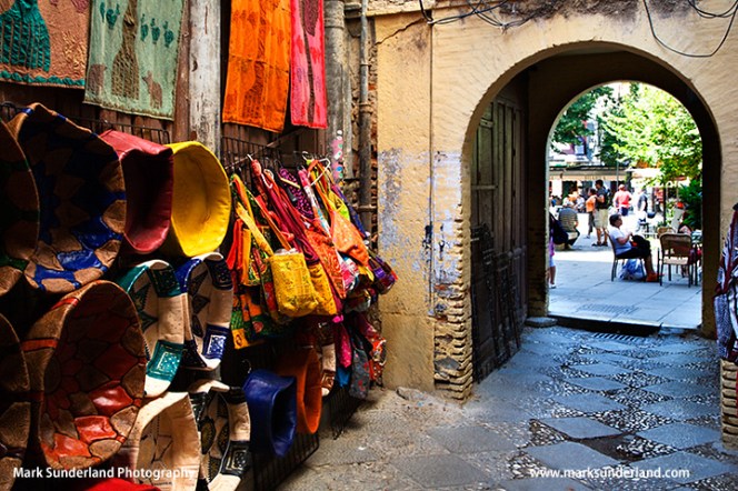 Looking through an archway to Plaza Bib Rambla from the Alcaiceria
