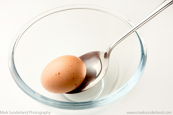 Brown Free Range Egg and Tablespoon in a Glass Bowl
