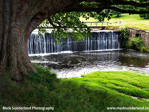 Dam on the River Skell forming the Ornamental Lake at Studley Park near Ripon North Yorkshire England
