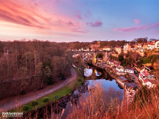 Pink sky at dusk over the Railway Viaduct from the Castle Grounds in Knaresborough