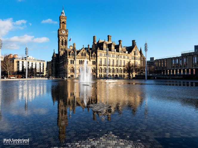 Bradford City Hall reflected in the Mirror Pool in City Park, Bradford