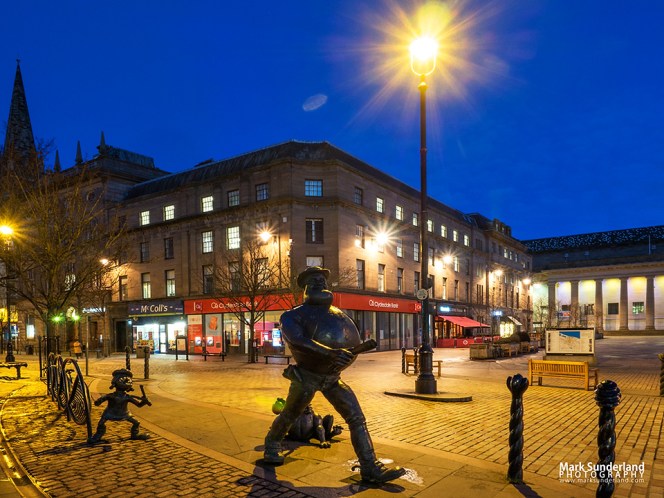 Desperate Dan and Minnie the Minx statues and City Square at dusk Dundee Scotland